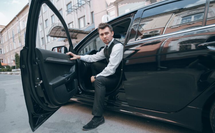 man in business attire in a car